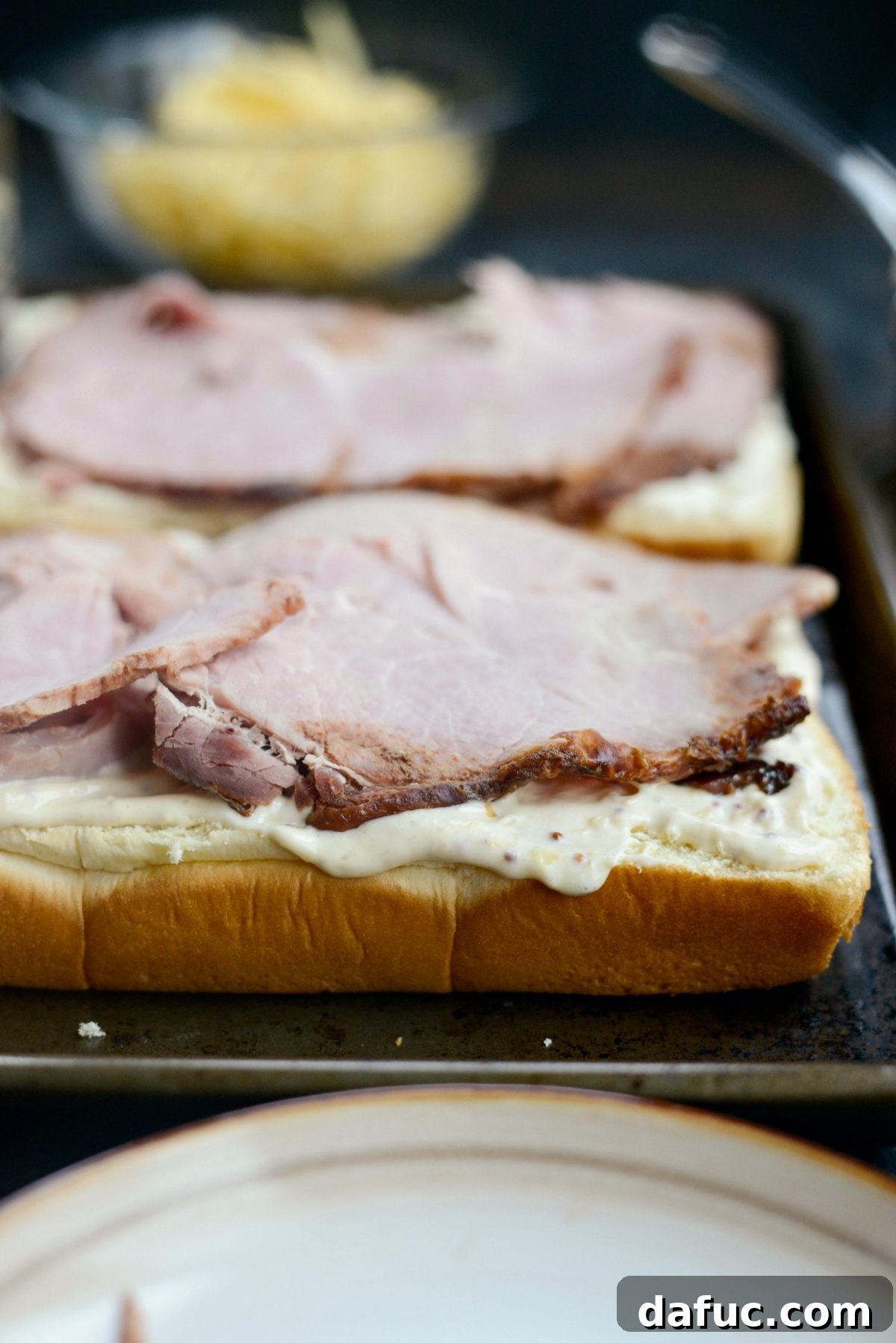 Gourmet Ham and Gouda Bites with Zesty Roasted Garlic Dijon 8 Layering ham slices onto the prepared dinner rolls
