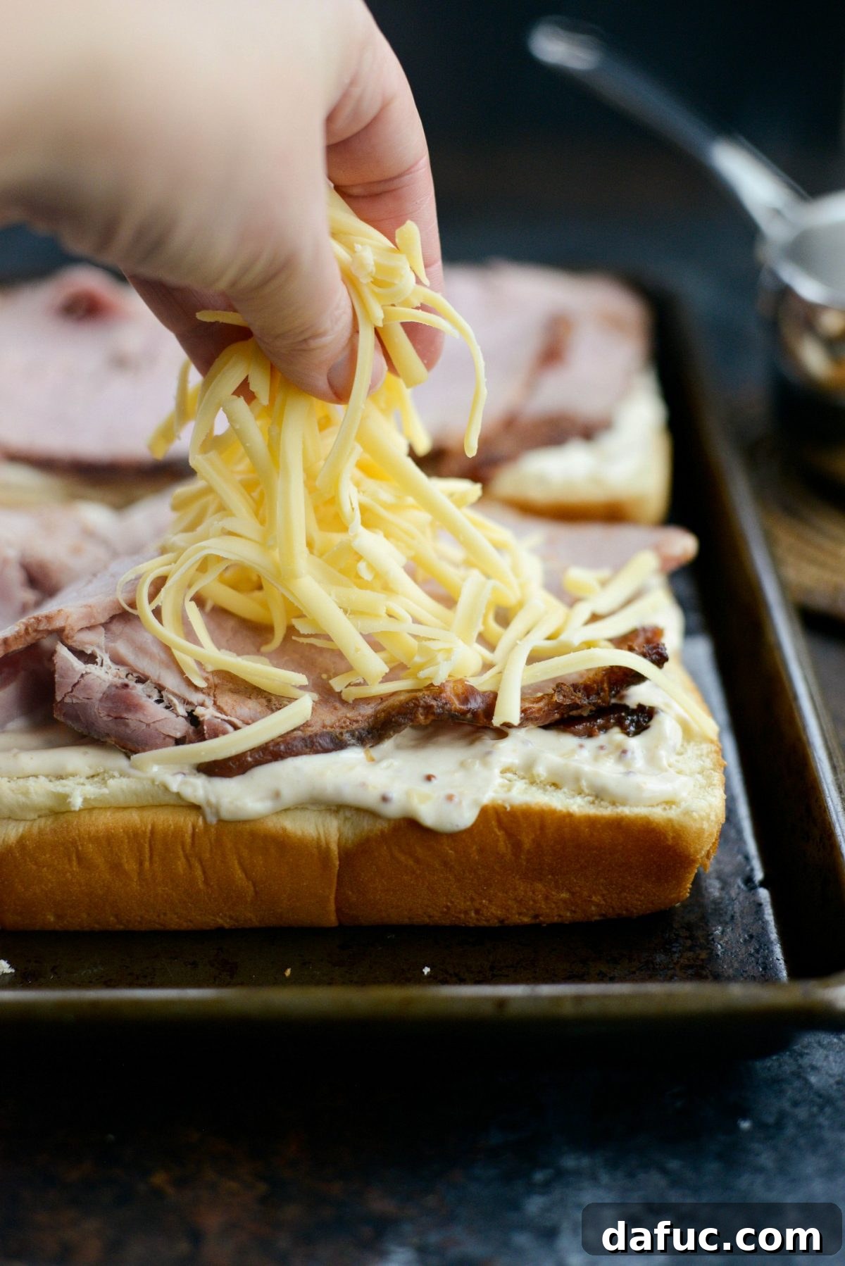 Gourmet Ham and Gouda Bites with Zesty Roasted Garlic Dijon 9 Sprinkling shredded Gouda cheese generously over the ham