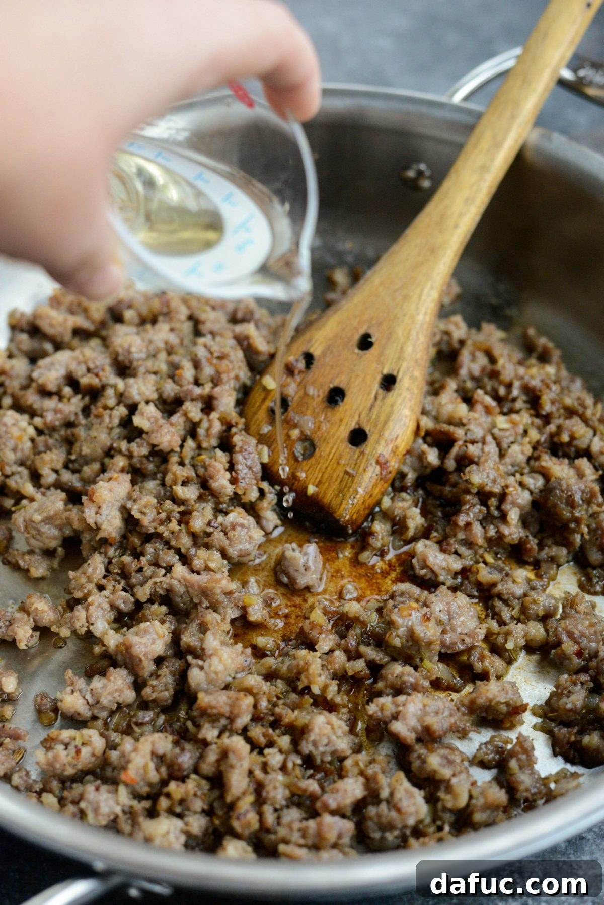Pouring white wine into the skillet