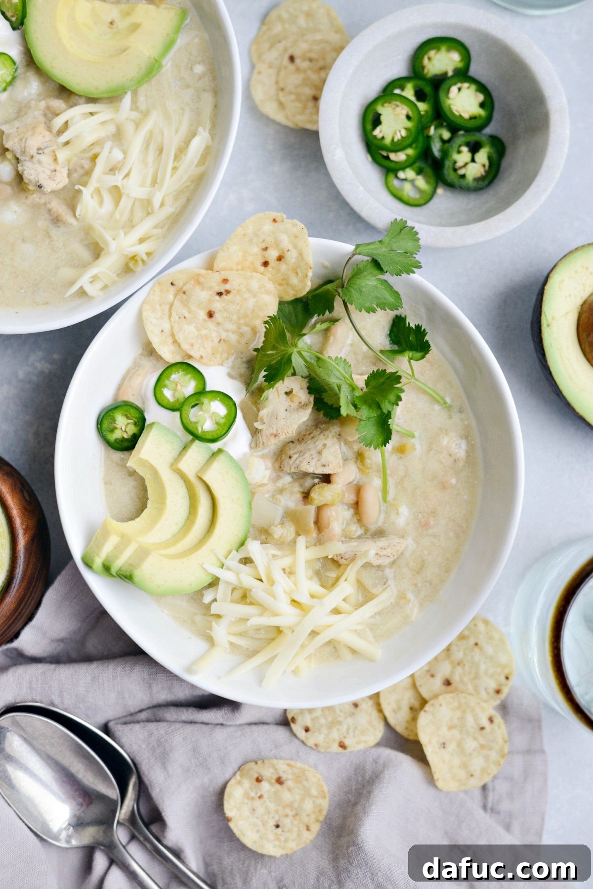 A large serving of Lighter White Chicken Chili with various toppings.