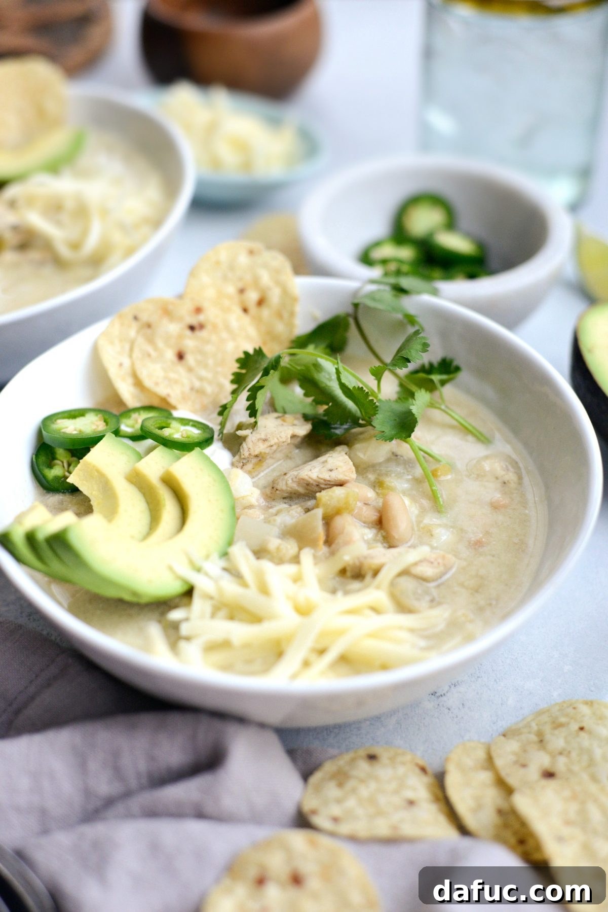Close-up of a serving of Lighter White Chicken Chili with fresh toppings.
