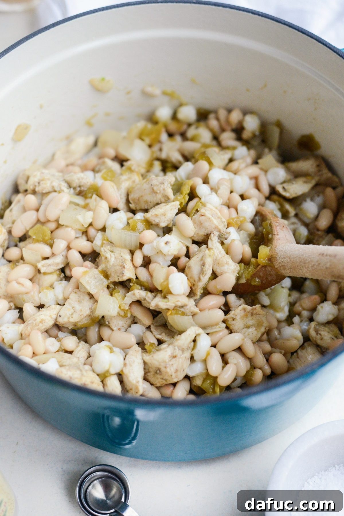 Stirring all the combined ingredients in the pot.