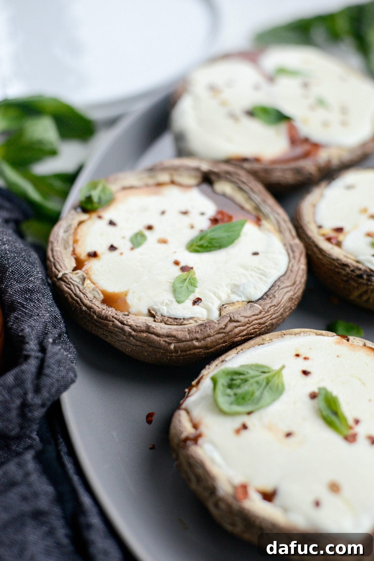 Caprese Stuffed Roasted Portobello Caps 3 Close-up of perfectly roasted Caprese Portobello Mushrooms with melted mozzarella