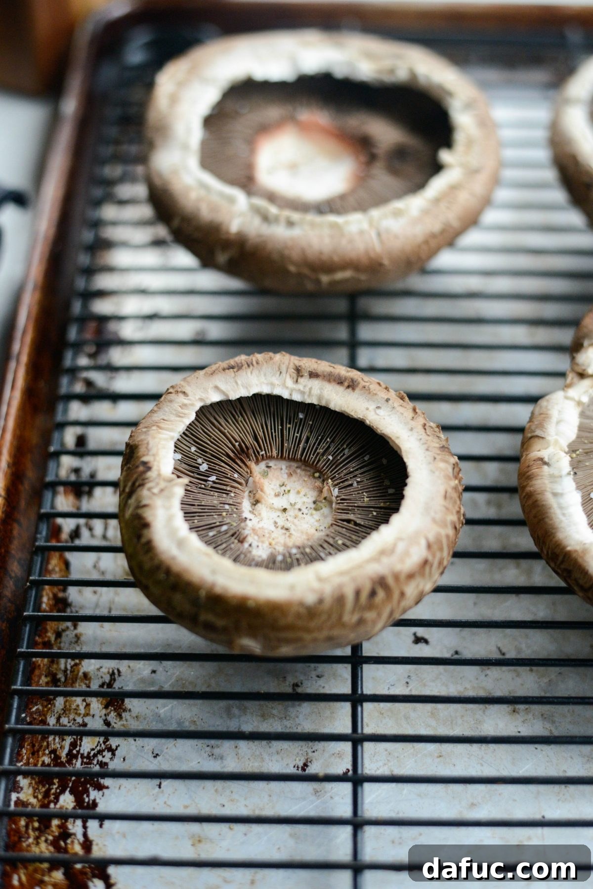 Caprese Stuffed Roasted Portobello Caps 6 Seasoned portobello mushroom caps on a wire rack