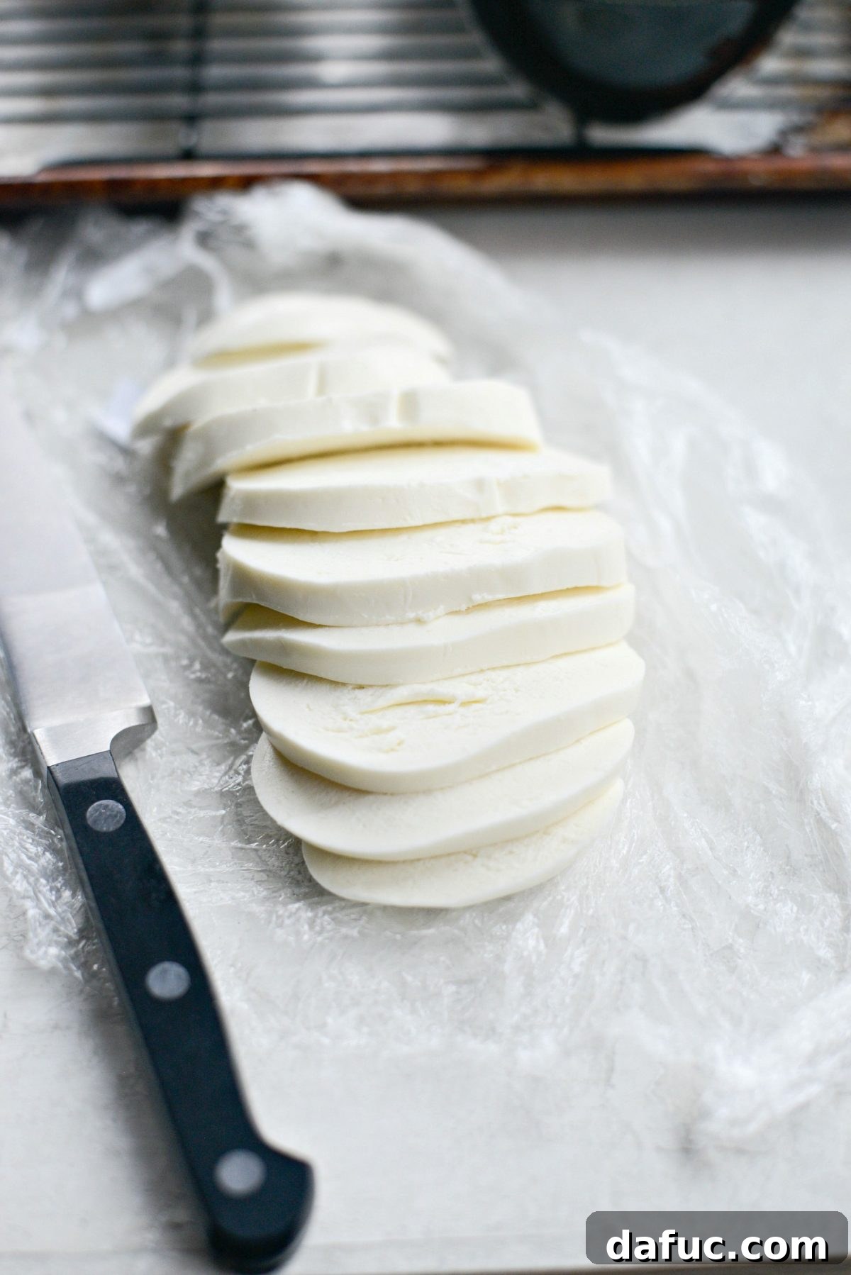 Caprese Stuffed Roasted Portobello Caps 9 Slicing fresh mozzarella for Caprese Portobello Mushrooms