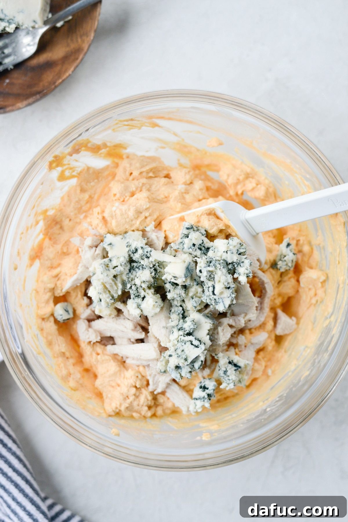Add in cooked shredded chicken and blue cheese crumbles