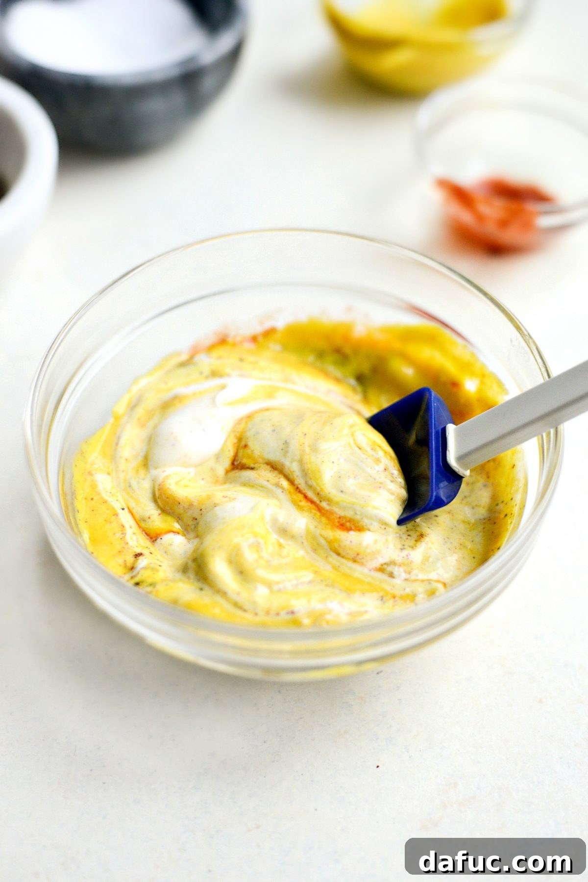 Stirring spicy mustard dip ingredients