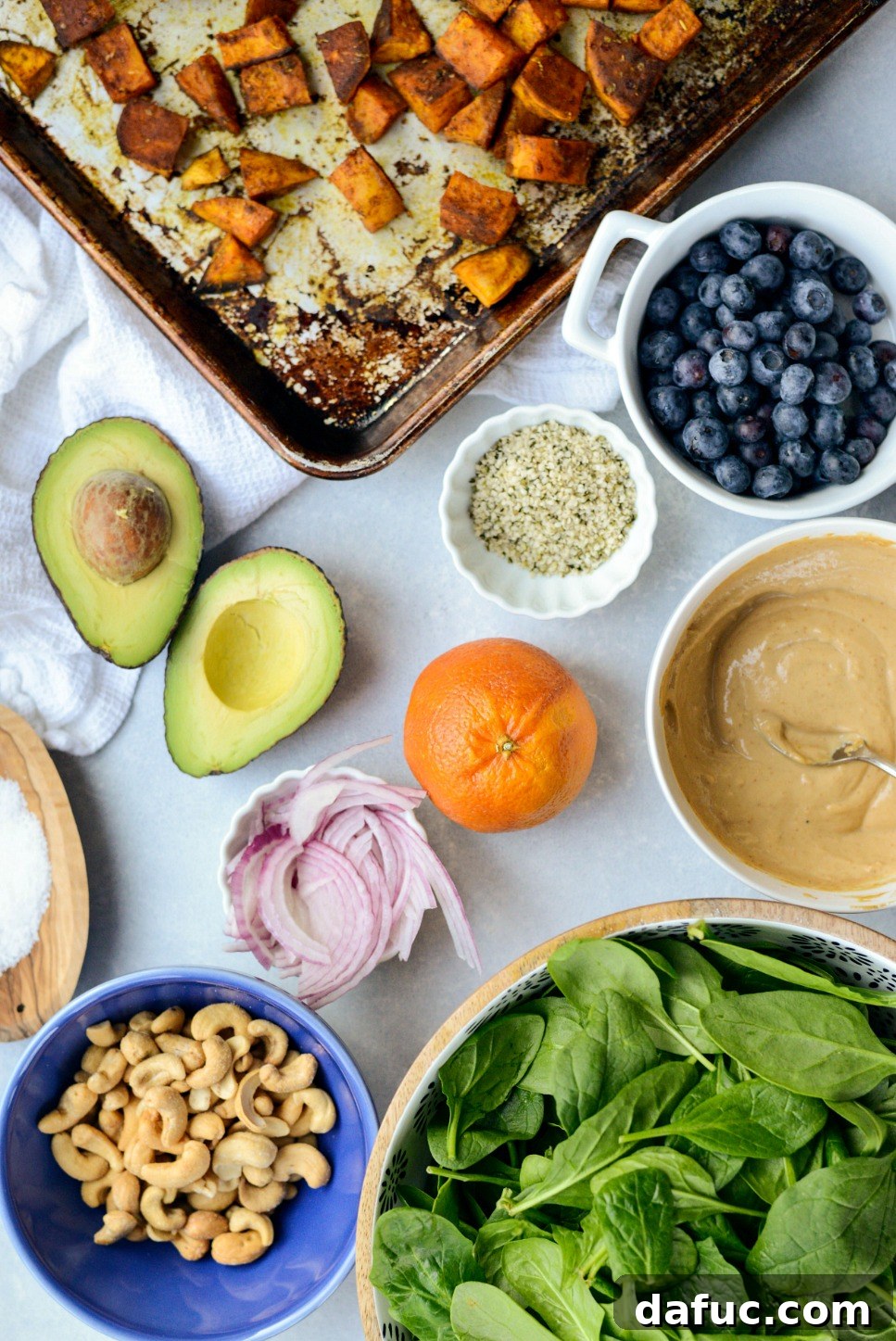 Sweet Potato Blueberry Radiance Bowl 4 Fresh ingredients laid out for the Sweet Potato Blueberry Power Bowl recipe, including sweet potatoes, blueberries, spinach, avocado, and cashews.
