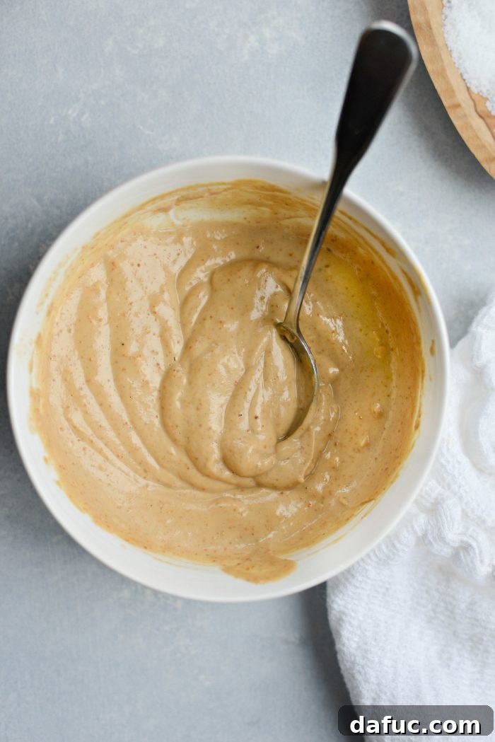Sweet Potato Blueberry Radiance Bowl 7 A jar of homemade Creamy Cashew Dressing, showcasing its smooth, rich texture.