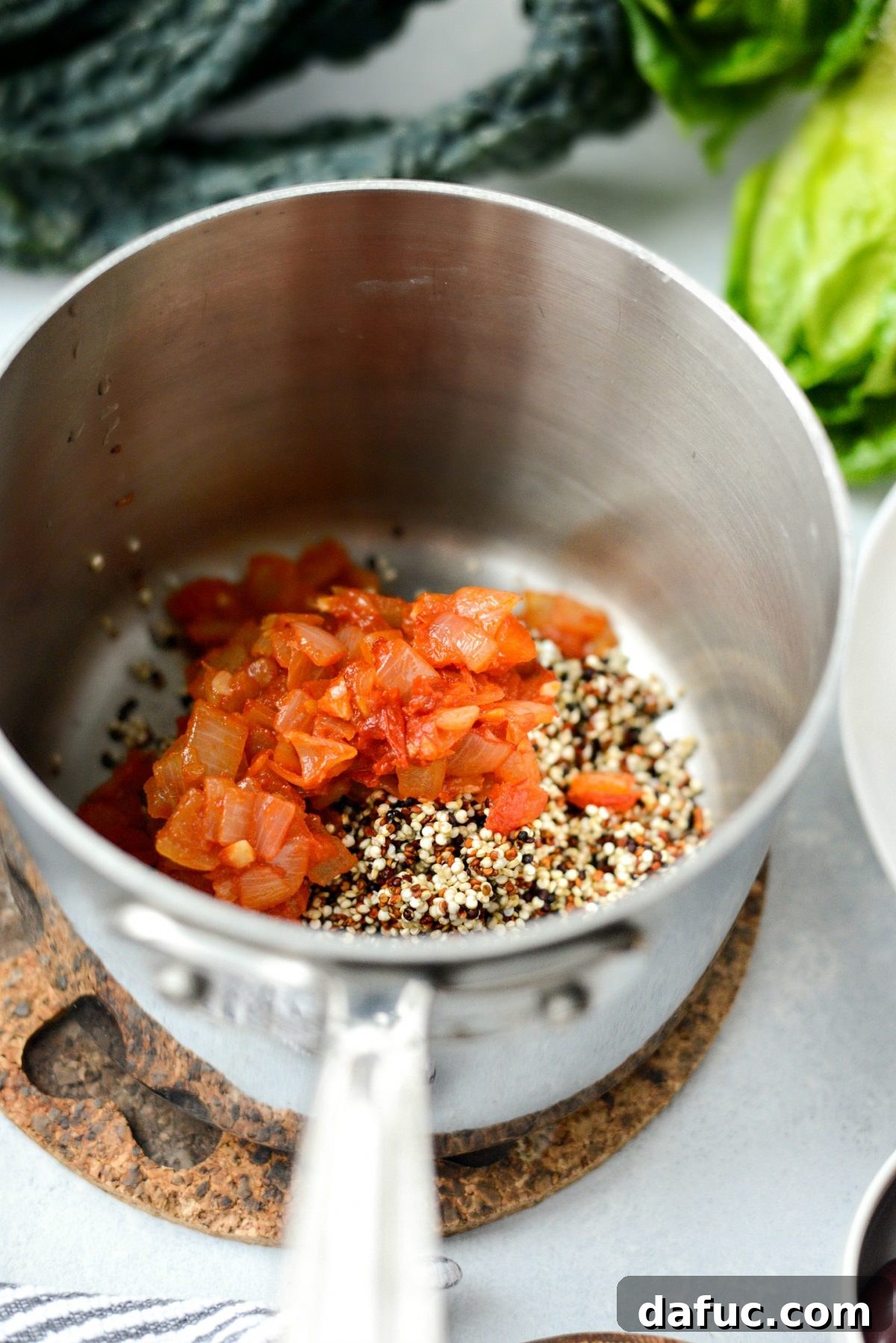 Quinoa and sofrito simmering in a saucepan