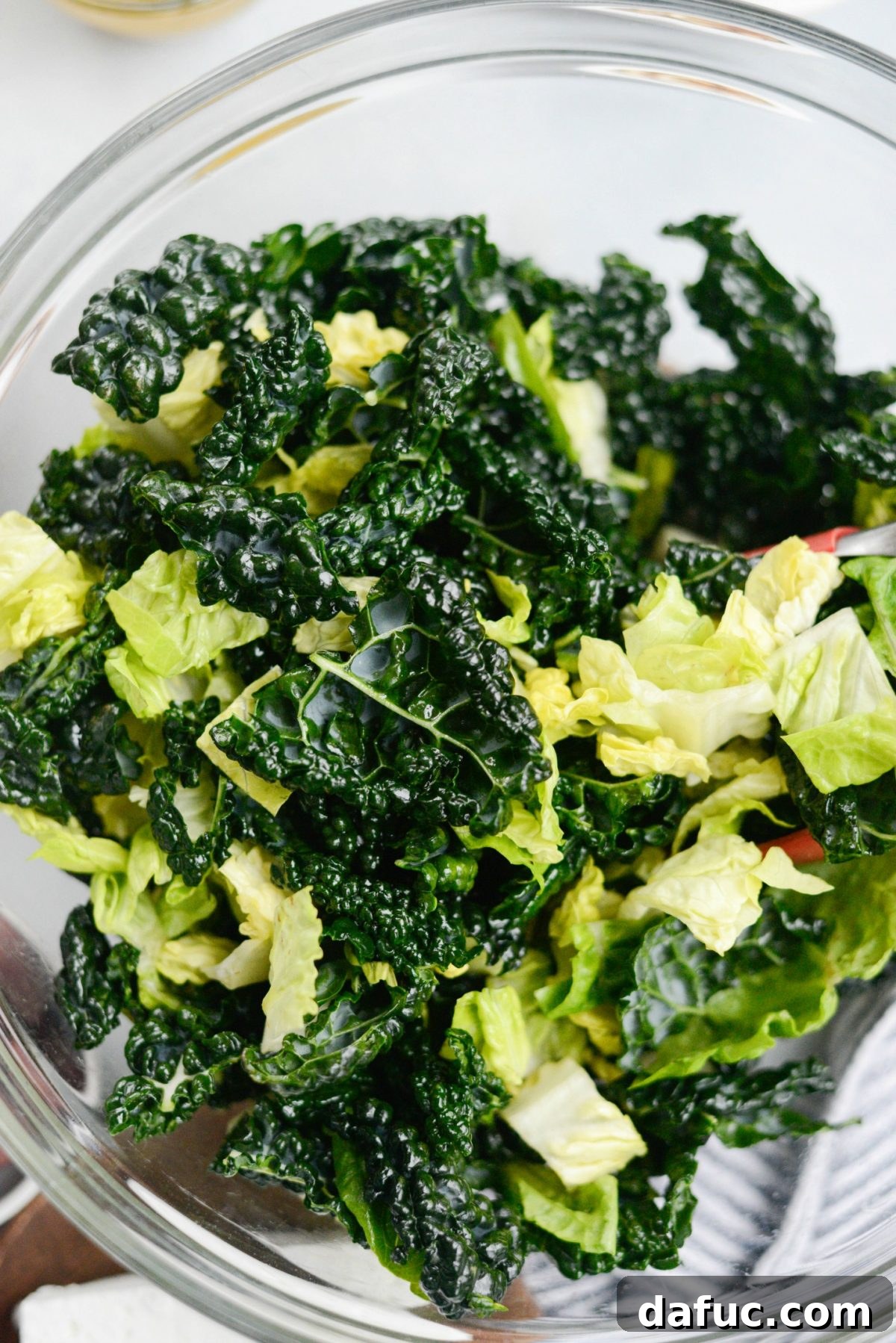 Massaging kale leaves with olive oil and salt