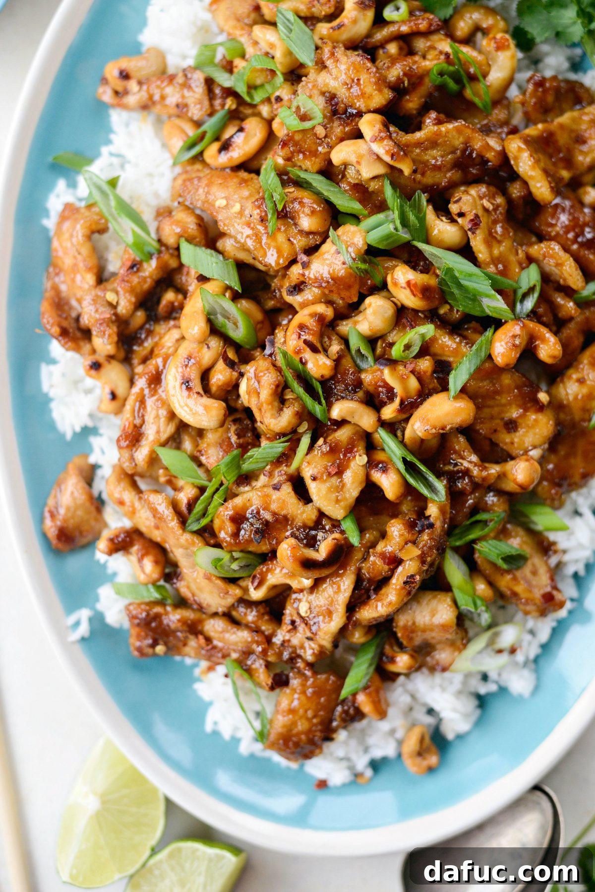 Spicy Ginger Cashew Pork Stir-Fry in a wok with cashews and cilantro