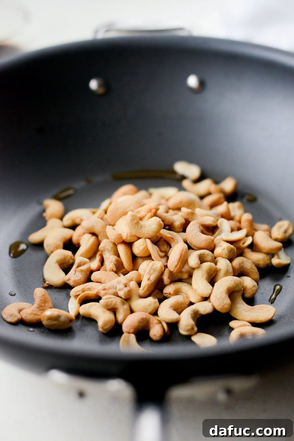 Toasting cashews in a hot wok