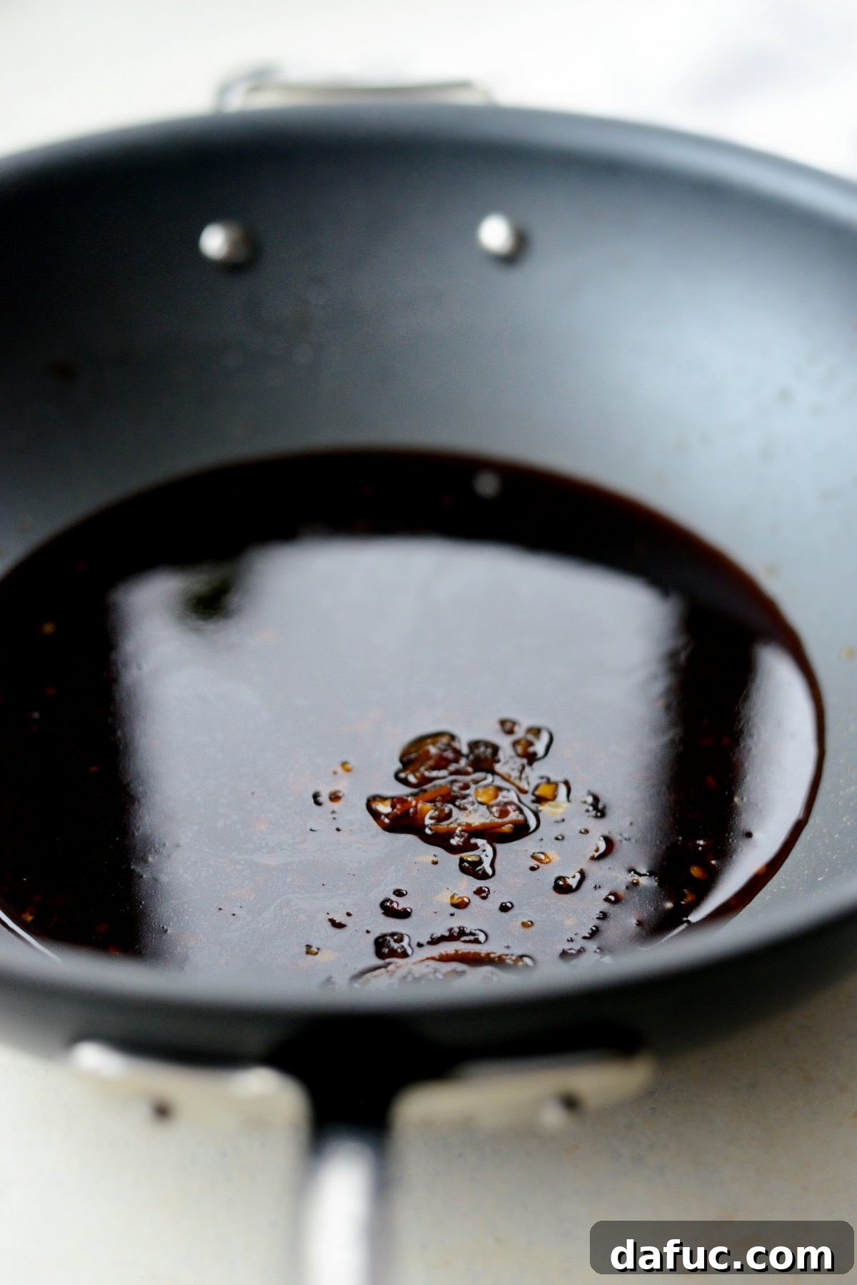 Adding the prepared sauce to a hot wok
