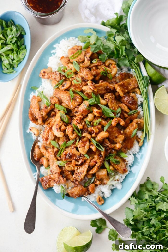 Close-up of Spicy Ginger Cashew Pork with green onions and chili flakes