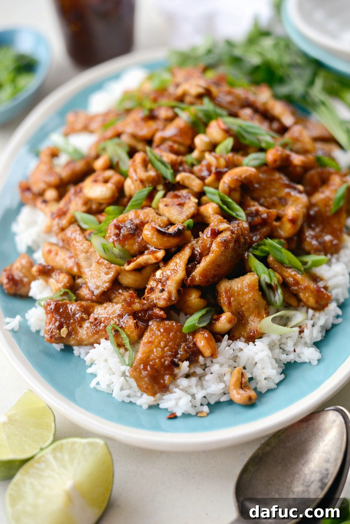 Overhead shot of Spicy Ginger Cashew Pork in a bowl with chopsticks