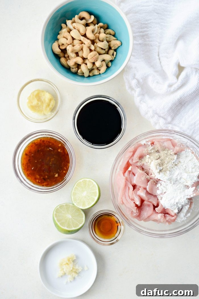 Ingredients laid out for Spicy Ginger Cashew Pork, including pork, cashews, ginger, garlic, and sauce components
