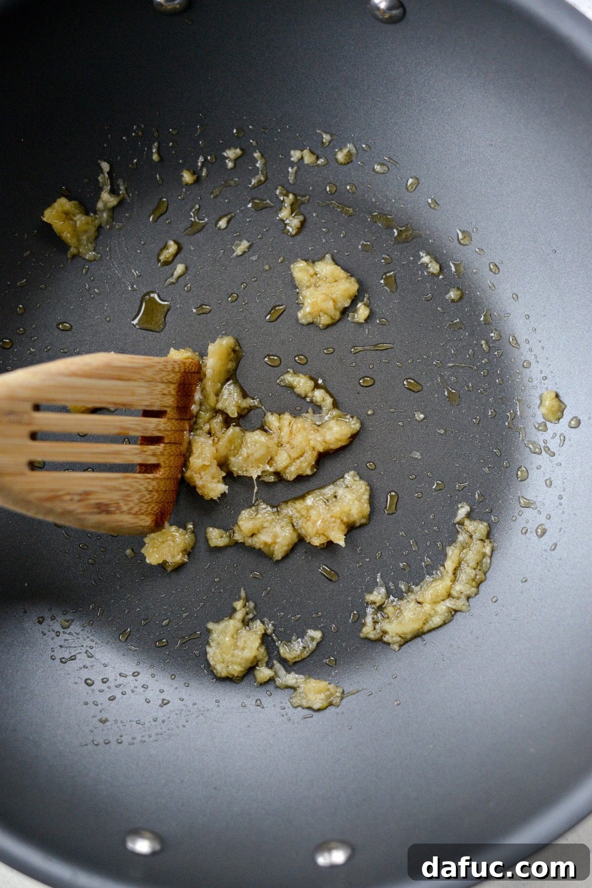 Stir-frying garlic and ginger in a wok for 30 seconds