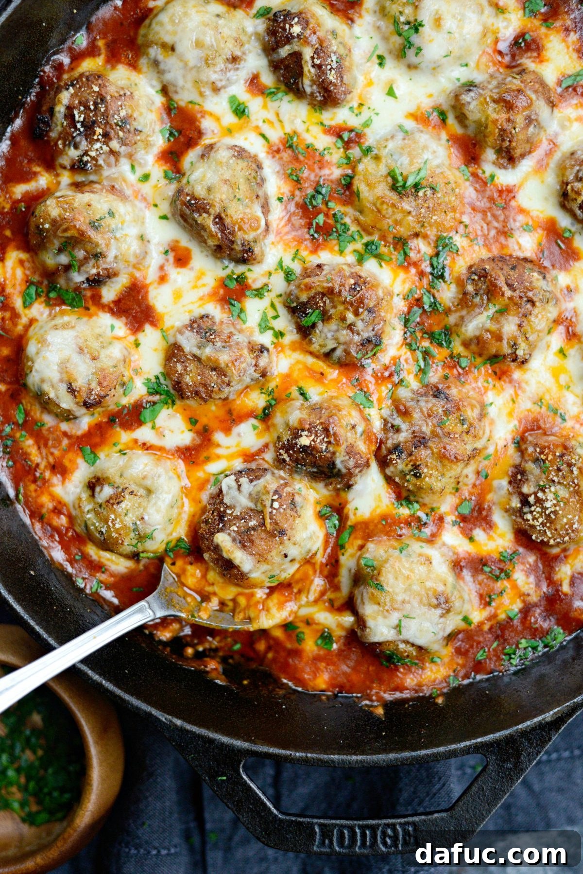 Chicken Parm Skillet Meatballs 2 Skillet Chicken Parmesan Meatballs cooking in a large cast iron skillet, ready to serve over pasta.