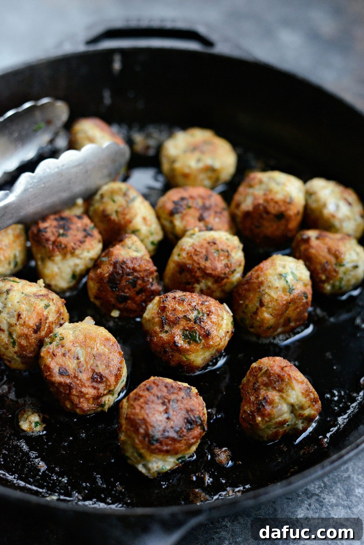 Chicken Parm Skillet Meatballs 11 Browning chicken parmesan meatballs in a hot cast iron skillet.