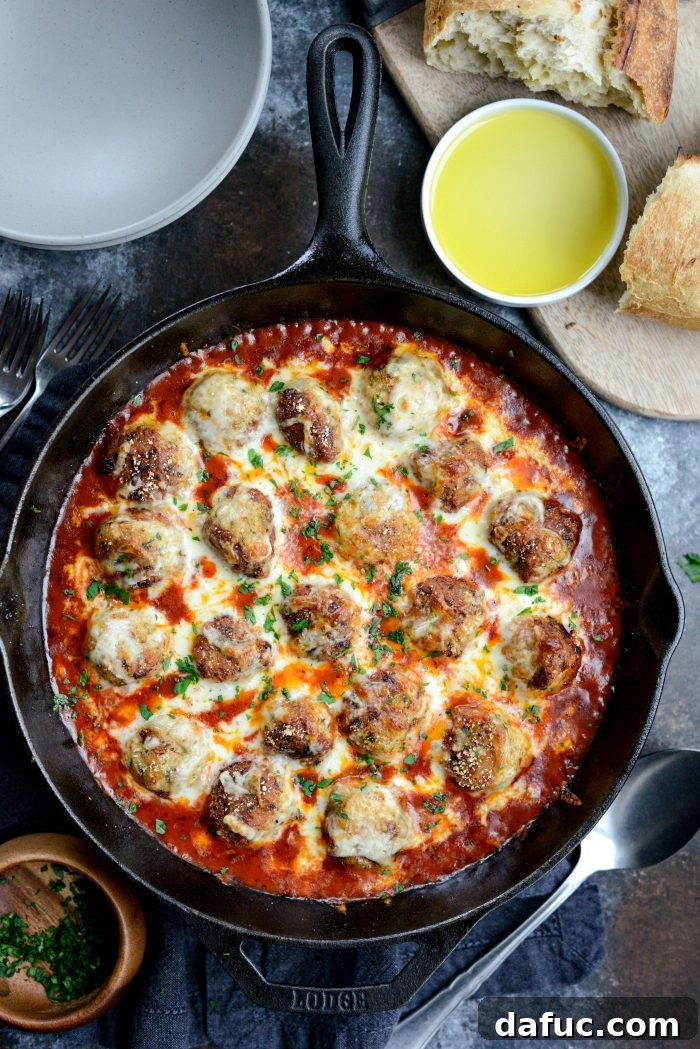 Chicken Parm Skillet Meatballs 18 Skillet Chicken Parmesan Meatballs served in a bowl with spaghetti squash noodles and a side of crusty bread.