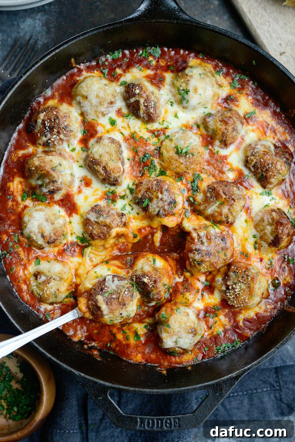 Chicken Parm Skillet Meatballs 3 Two Skillet Chicken Parmesan Meatballs in a skillet, showcasing the cheesy topping and rich marinara.