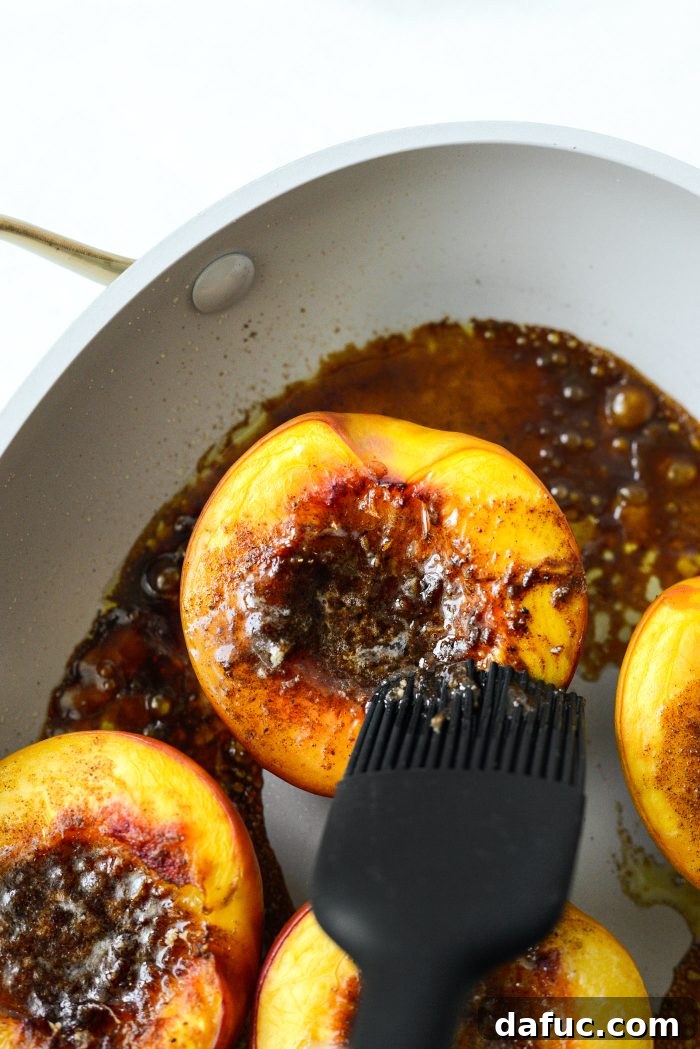 Warm Vanilla Cardamom Nectarine Bake 13 Brushing baked nectarines with the buttery brown sugar glaze
