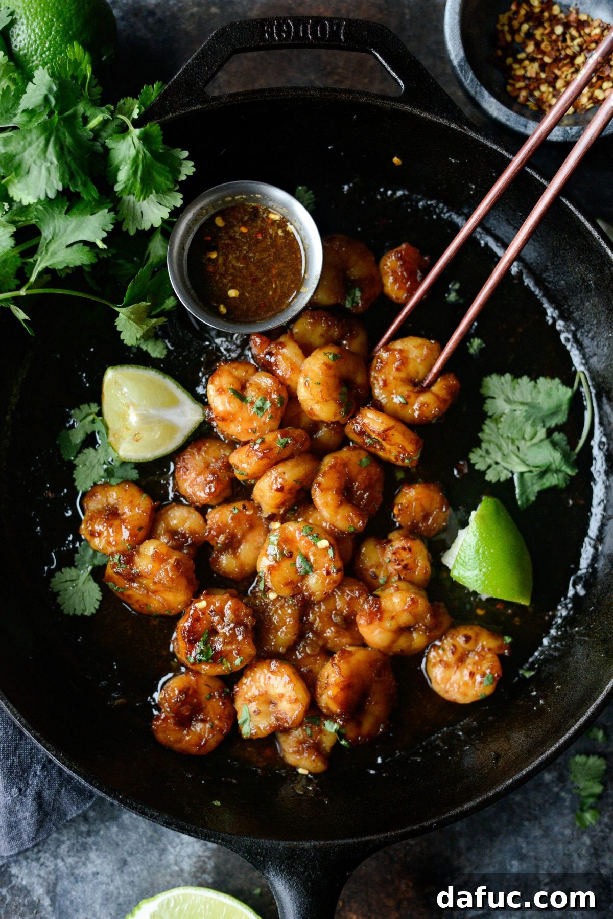 Plated Glazed Hot Honey Garlic Shrimp with lime and cilantro