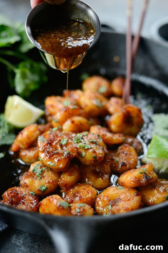 Close-up of Glazed Hot Honey Garlic Shrimp cooking in a skillet