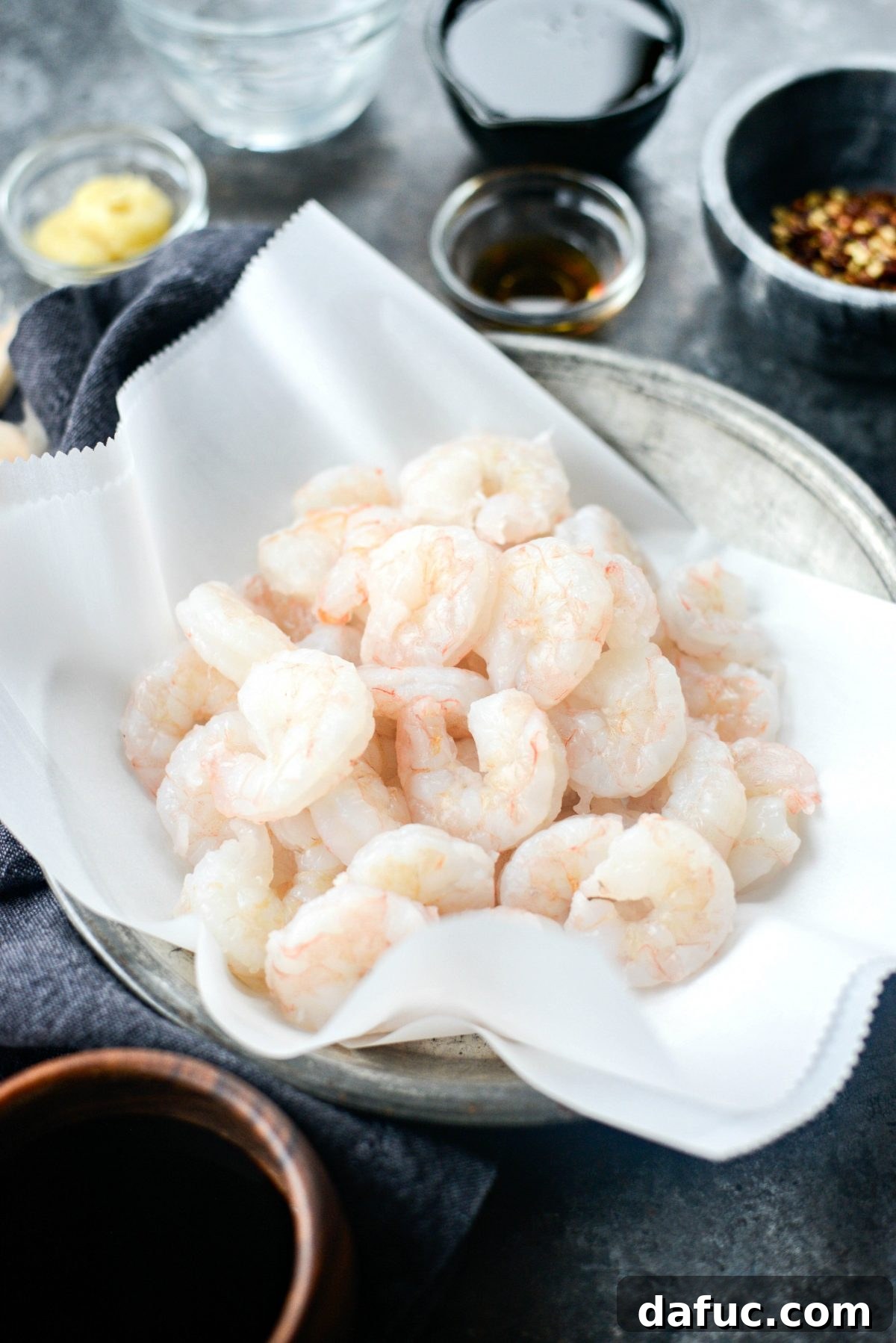 Thawing and patting dry shrimp for the recipe