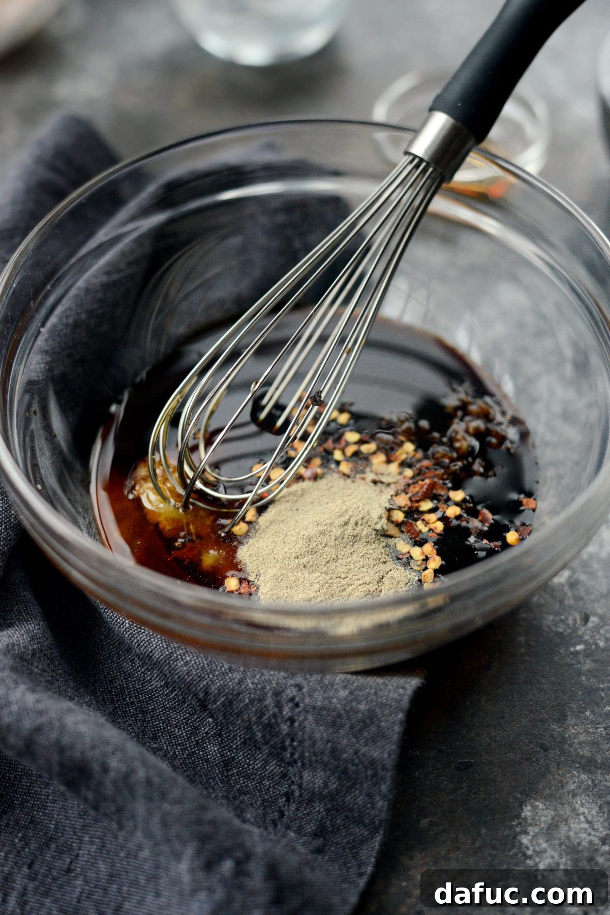 Measuring and adding sauce ingredients into a bowl