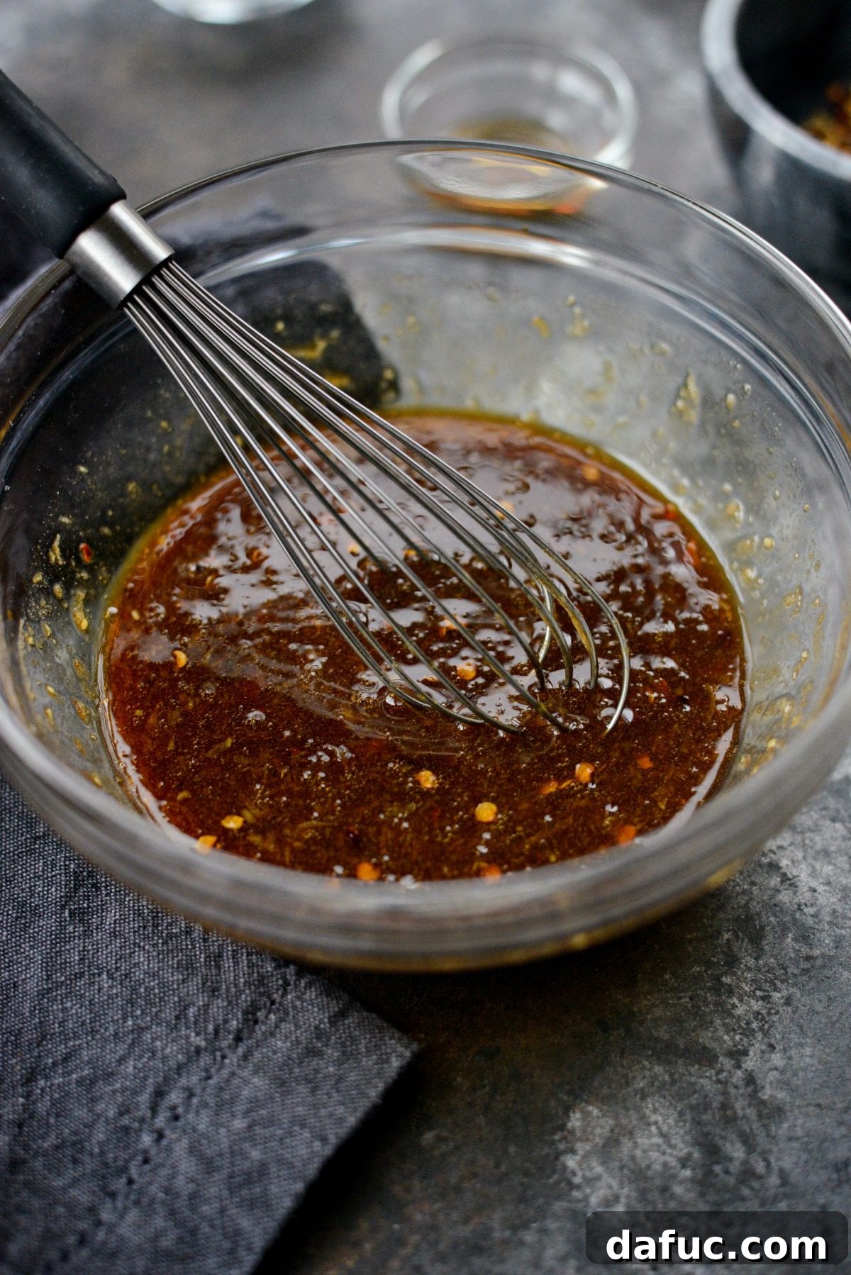 Whisking the honey garlic sauce to combine ingredients