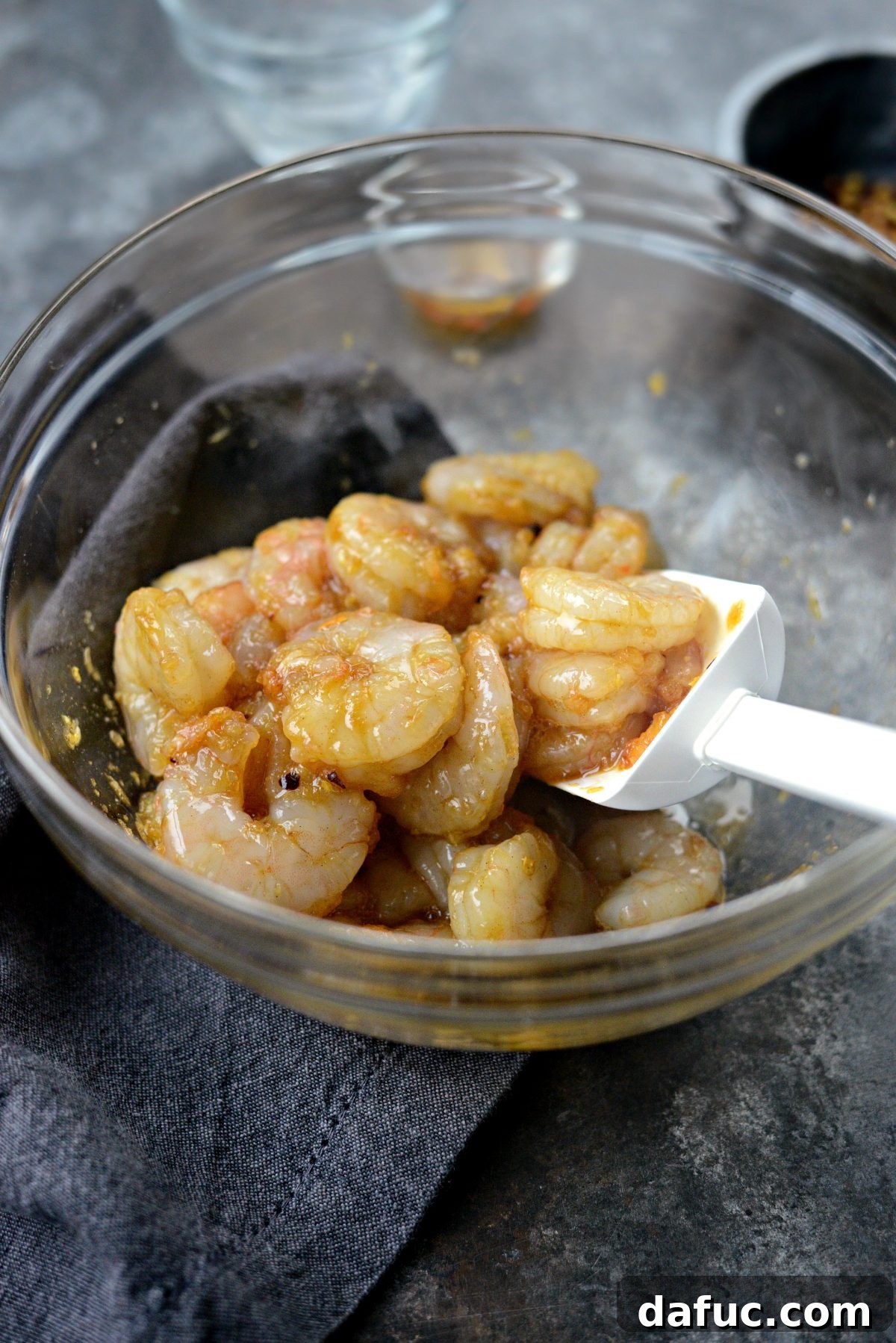 Tossing shrimp to coat evenly with the glaze
