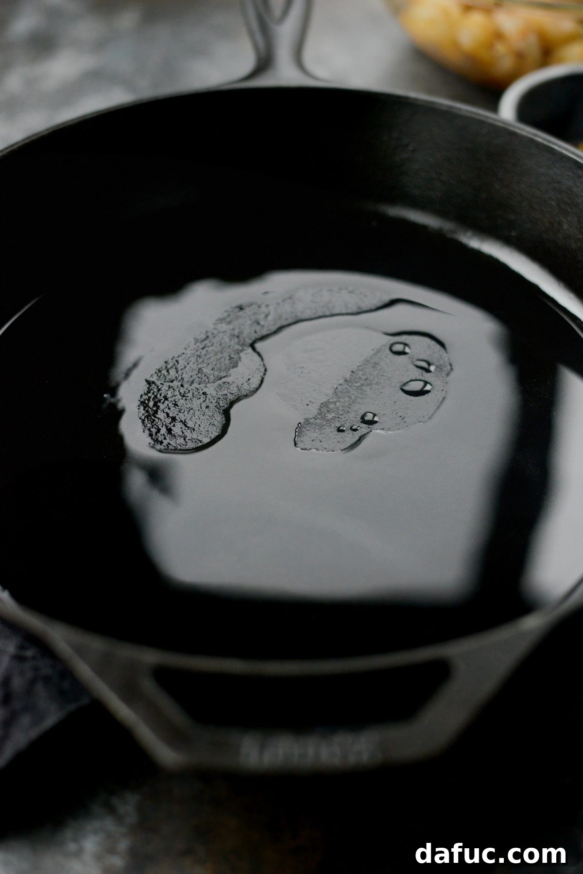 Heating coconut and sesame oil in a cast iron skillet