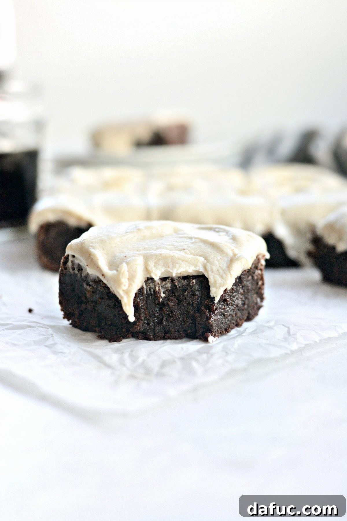 Rich Chocolate Guinness Brownies generously topped with creamy Brown Butter Stout Frosting, ready to be served