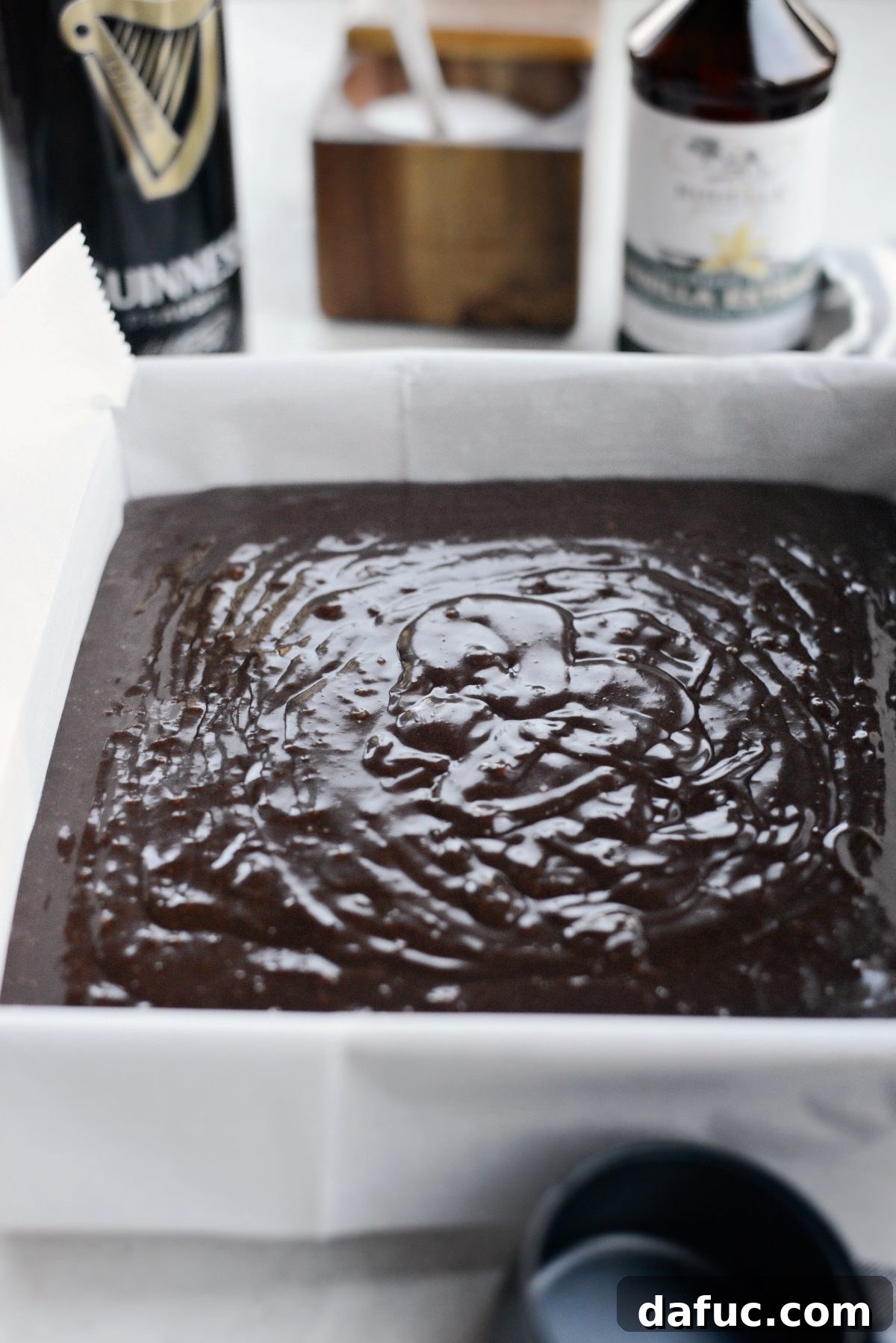 Brownie batter spread evenly in the baking pan, ready for the oven