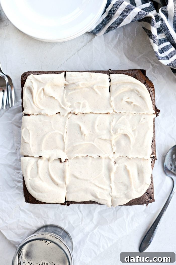 A top-down view of fully frosted Chocolate Guinness Brownies, showcasing the thick layer of brown butter stout frosting
