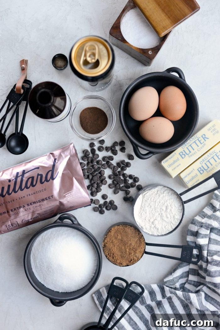 Assortment of key ingredients for making Chocolate Guinness Brownies, including chocolate, butter, eggs, sugars, espresso, salt, and Guinness beer