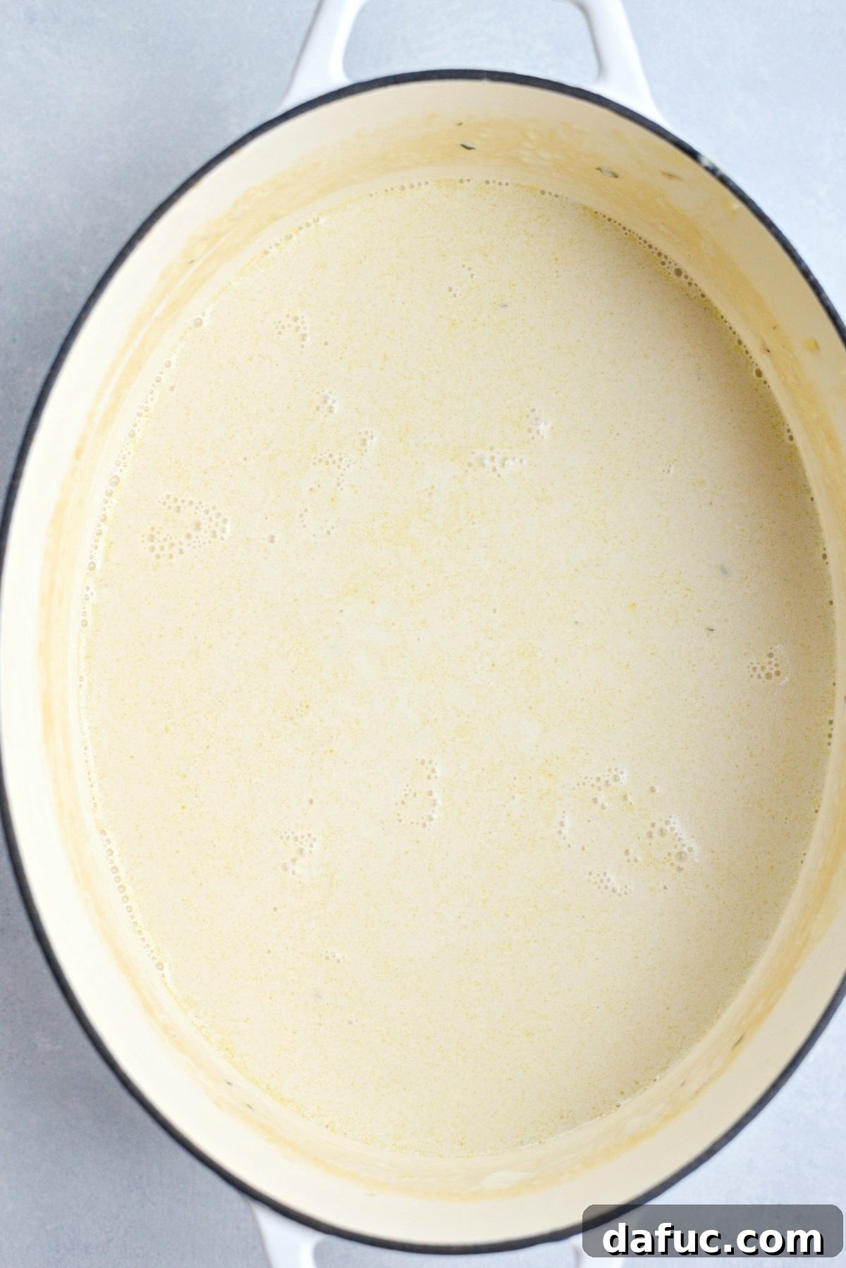 The clear, strained Irish Cheddar Beer Soup liquid in a clean pot, ready for cheese.