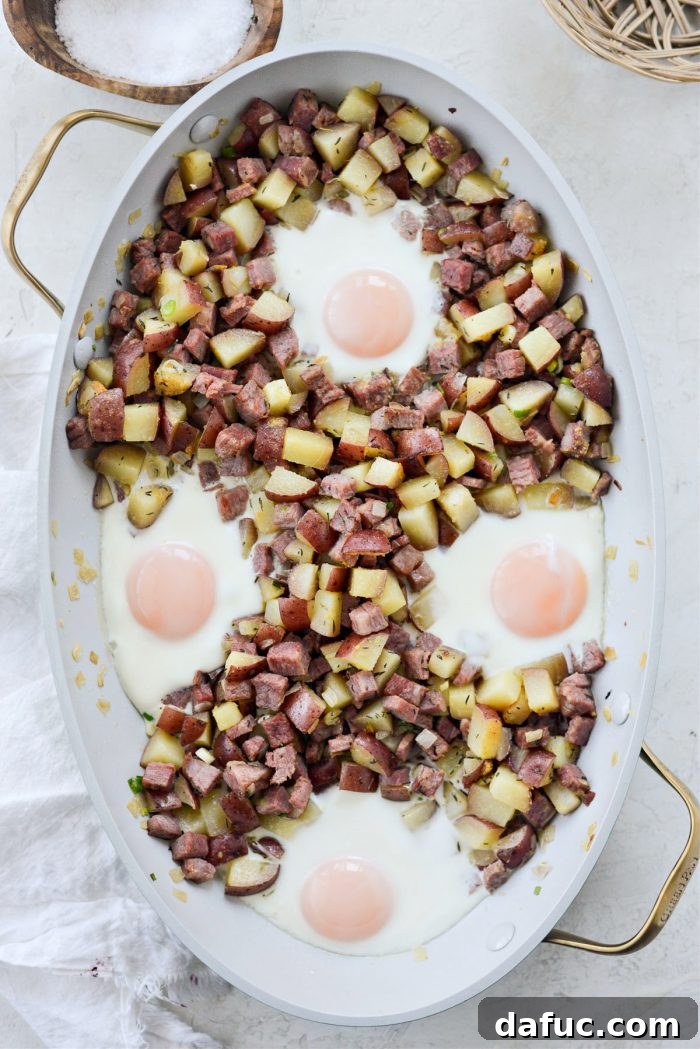 Freshly baked corned beef hash with eggs, hot out of the oven, yolks still slightly runny.