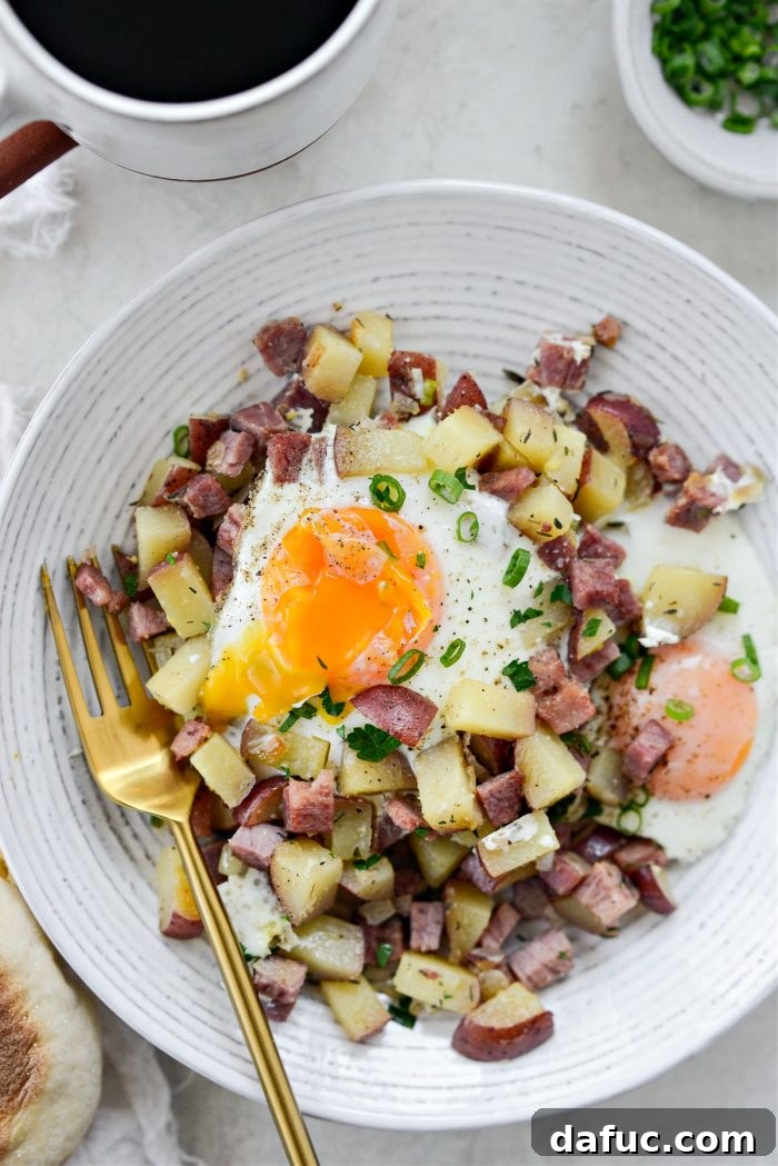 A final, mouth-watering shot of the easy homemade corned beef hash with eggs in the skillet, ready to be enjoyed.