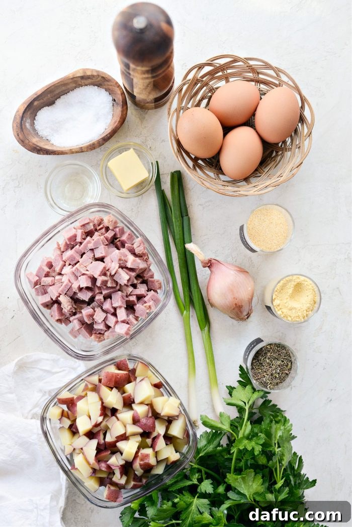 Array of fresh ingredients including potatoes, corned beef, eggs, green onions, and spices laid out for corned beef hash recipe.