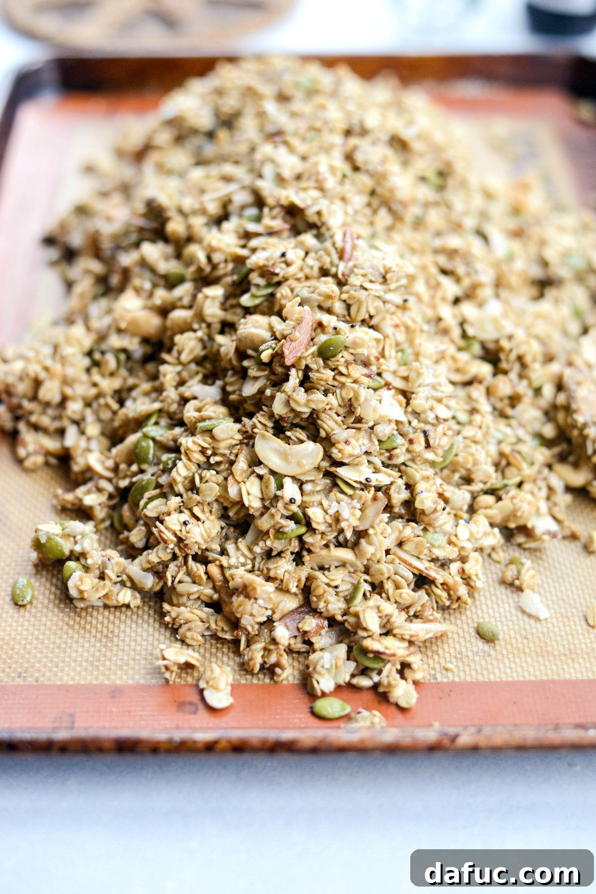 Add granola mixture to a lined, rimmed baking pan