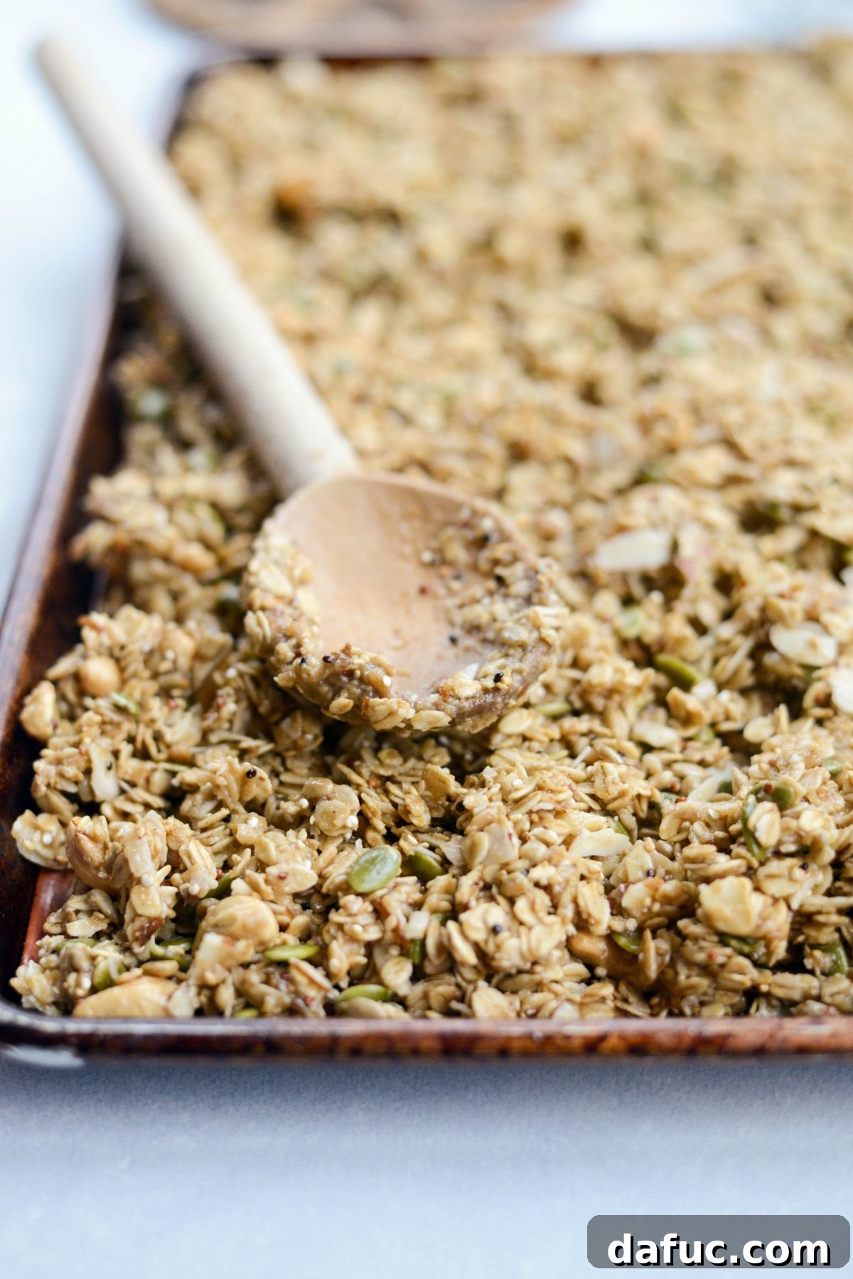 Spread granola evenly on baking sheets and bake