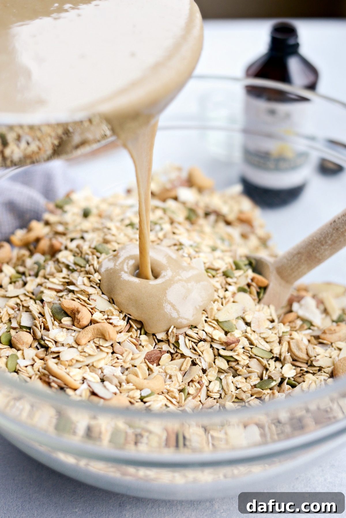 Pour tahini mixture over oats, nuts, and seeds