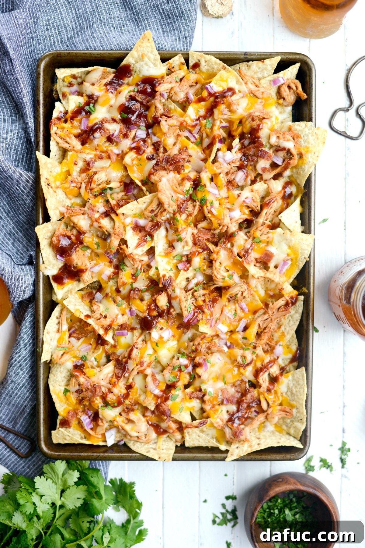 Baked Sheet Pan BBQ Chicken Nachos, hot and ready to serve.
