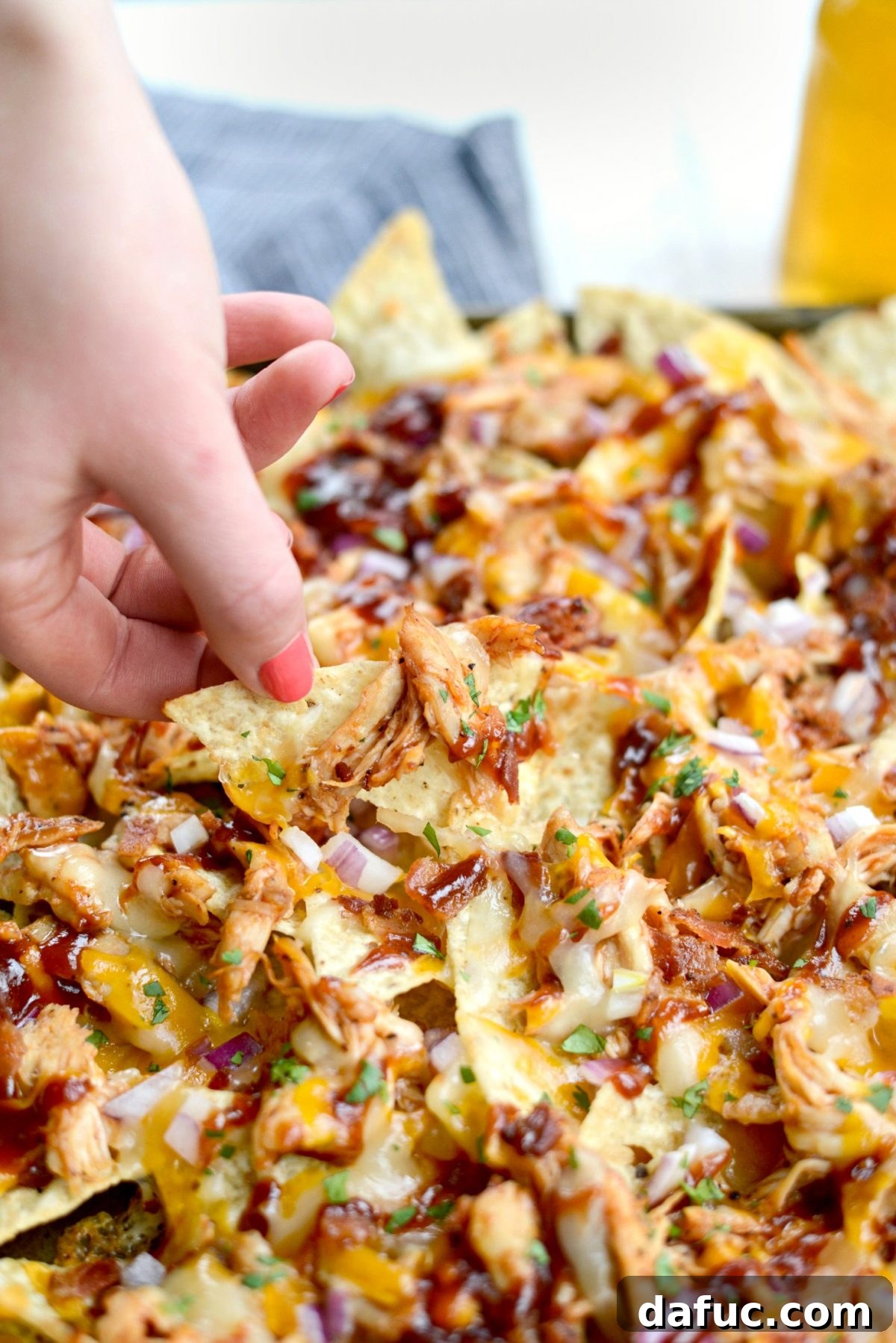 A large serving of Sheet Pan BBQ Chicken Nachos, ready to be devoured.
