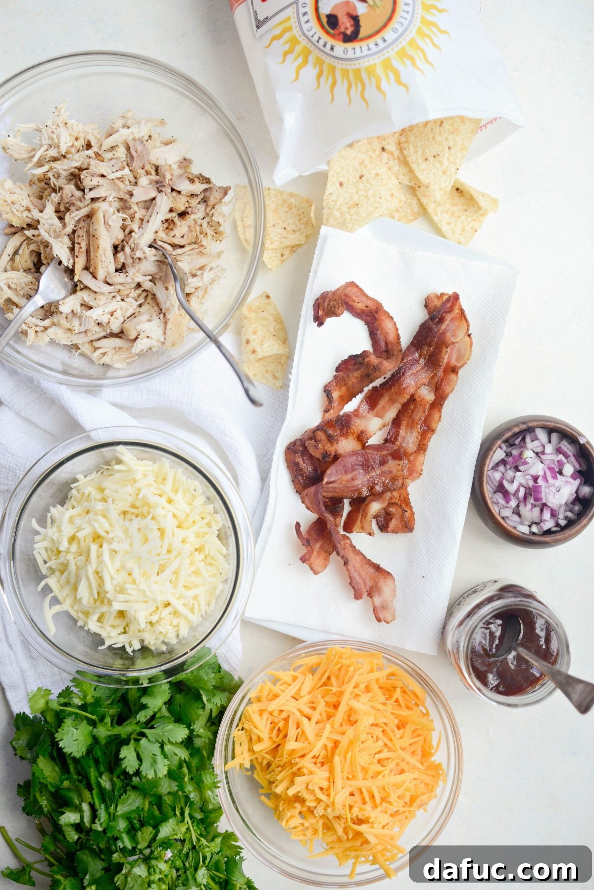 Ingredients for Sheet Pan BBQ Chicken Nachos laid out on a table.