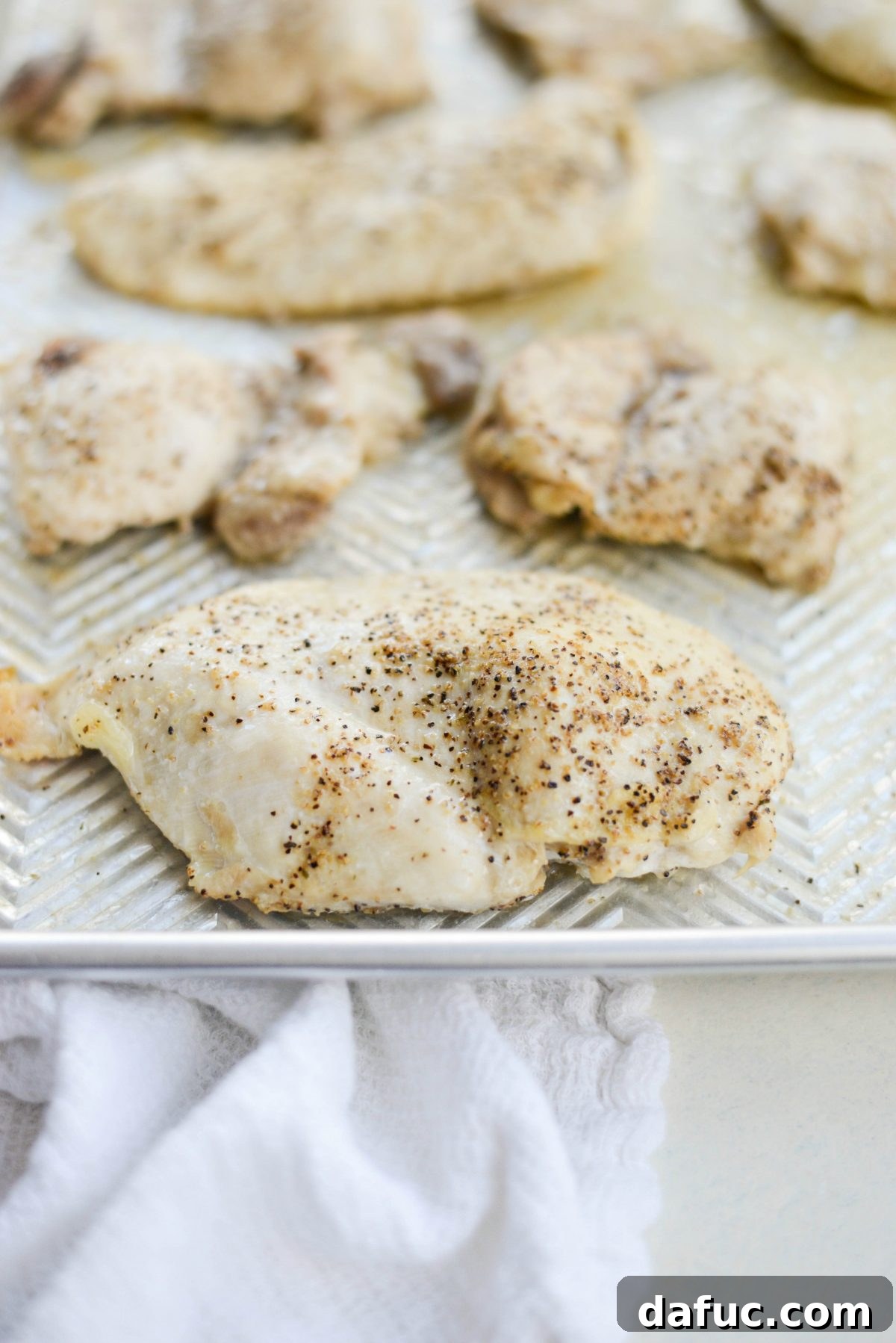 Cooked chicken breast and thigh ready to be shredded.