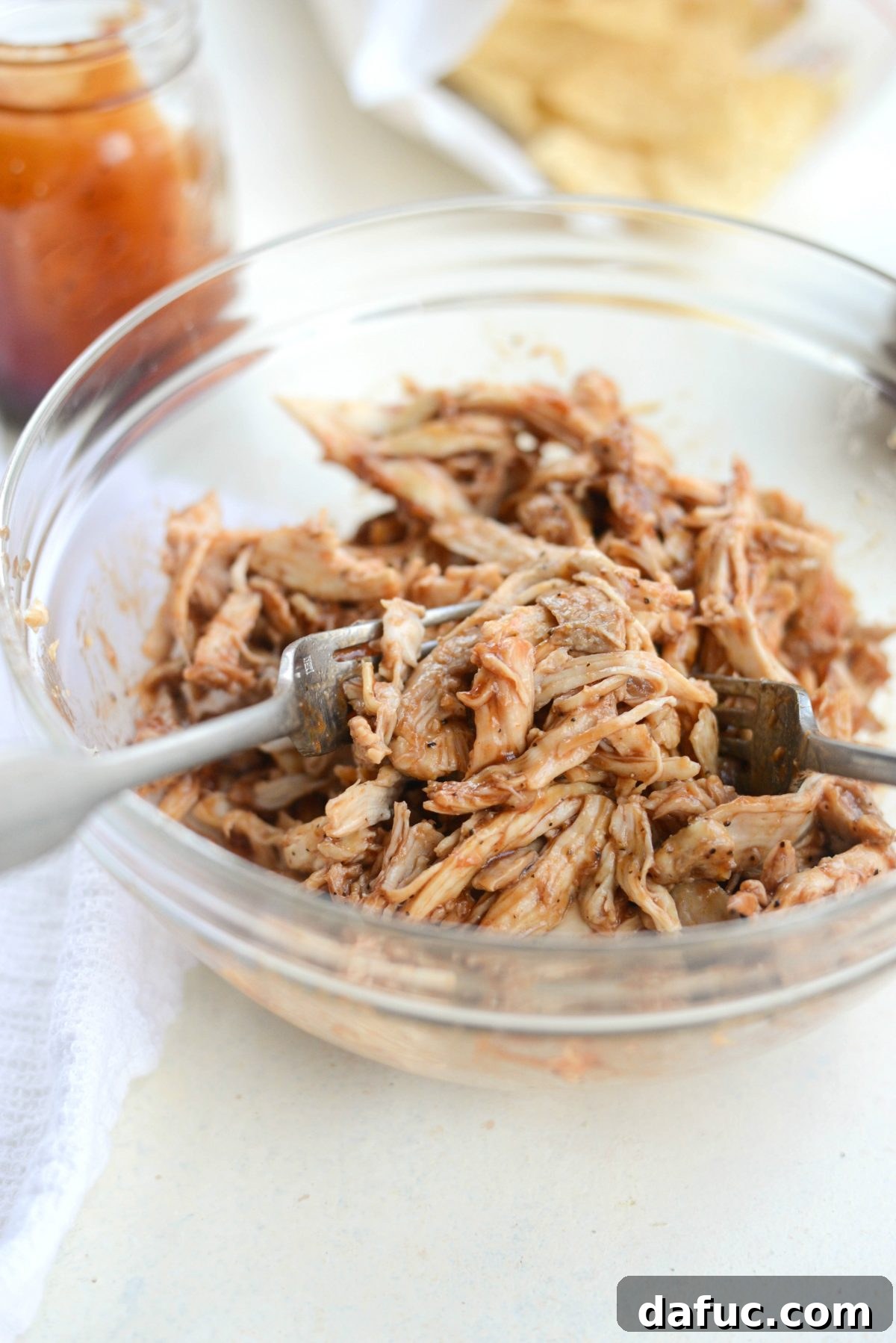 Saucy BBQ chicken ready for layering on nachos.